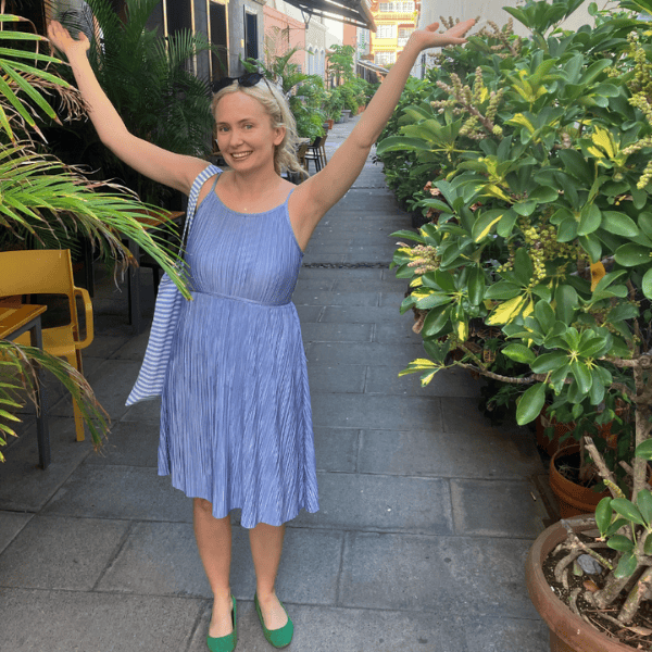 Happy Maria-Katarina Johannesson surrounded by green plants
